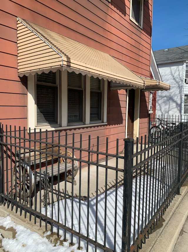 view of side of property featuring fence