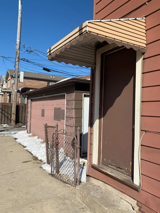 view of side of property with a garage and fence