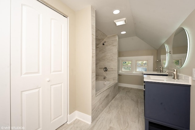 bathroom featuring shower / bathtub combination, lofted ceiling, vanity, baseboards, and a closet