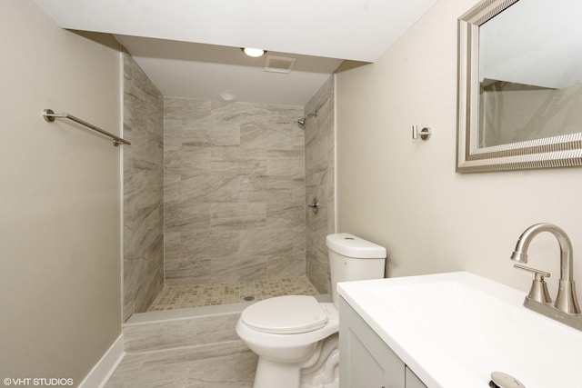 bathroom with toilet, a stall shower, visible vents, and vanity