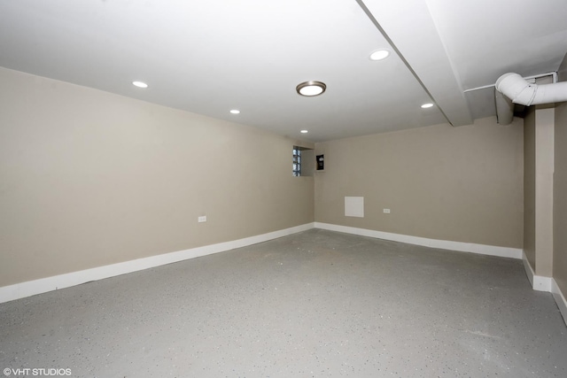 finished basement with baseboards and recessed lighting