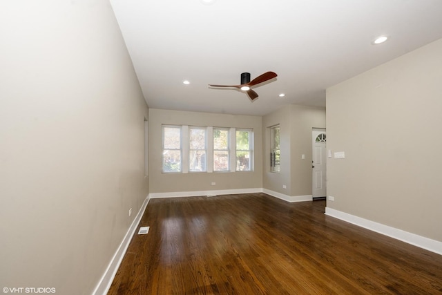 spare room featuring dark wood-style floors, recessed lighting, visible vents, and baseboards