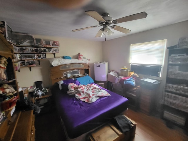 bedroom with ceiling fan and wood finished floors