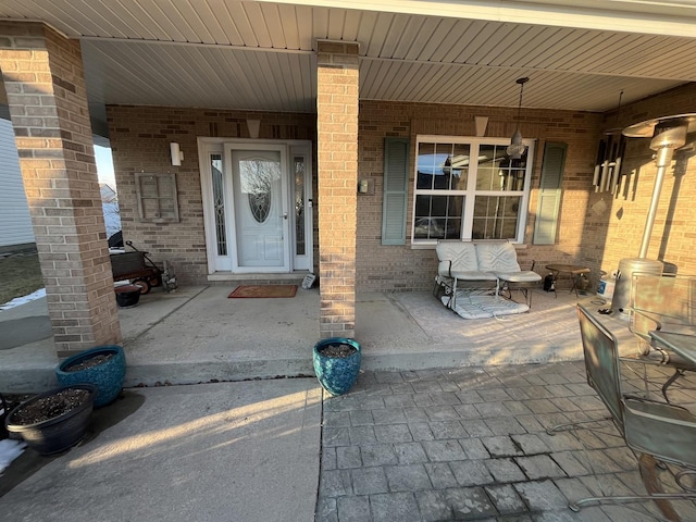 entrance to property featuring brick siding