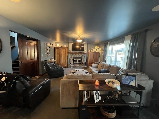 living area with carpet, a fireplace, and stairway