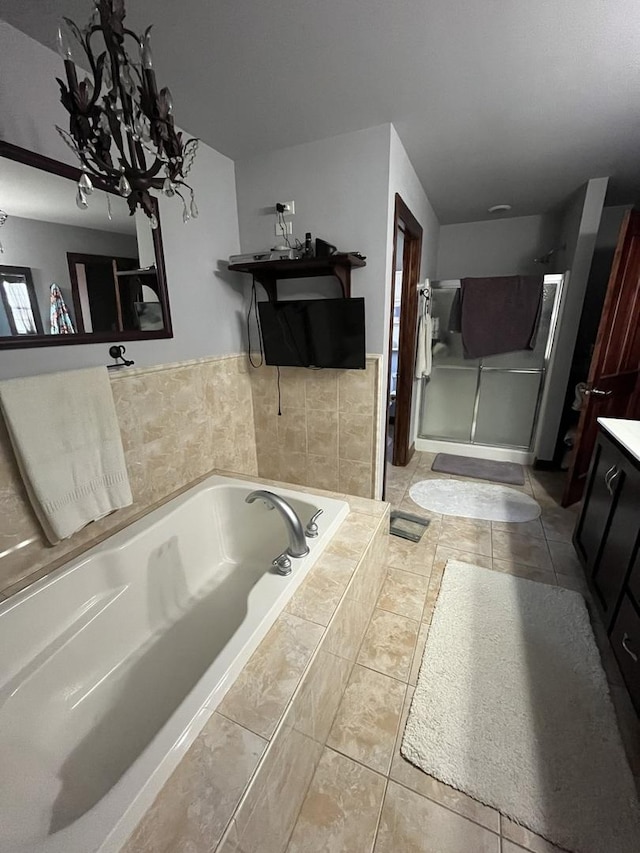 bathroom featuring tile patterned flooring, a bath, and vanity