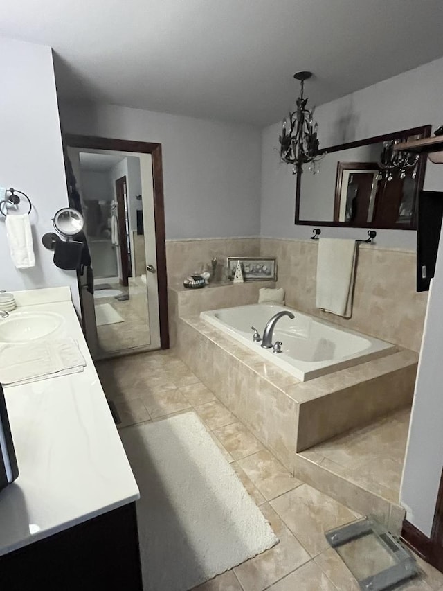 bathroom featuring tile patterned flooring, a chandelier, a bath, and vanity