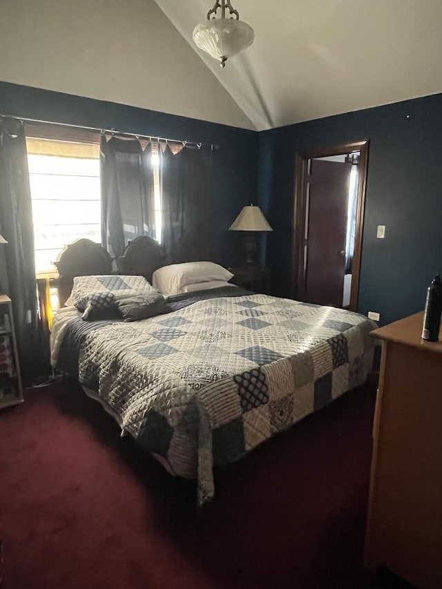 bedroom featuring lofted ceiling and carpet floors