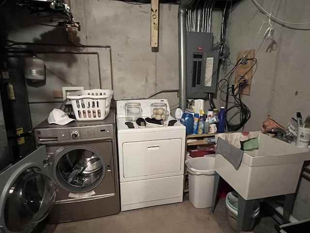 clothes washing area with laundry area, separate washer and dryer, a sink, and electric panel