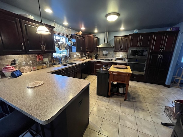 kitchen with a breakfast bar, a center island, oven, built in microwave, and wall chimney range hood