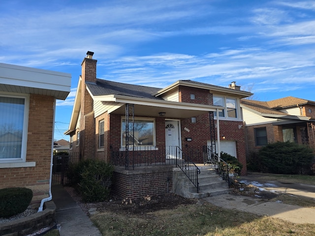 view of front of house featuring a chimney and brick siding