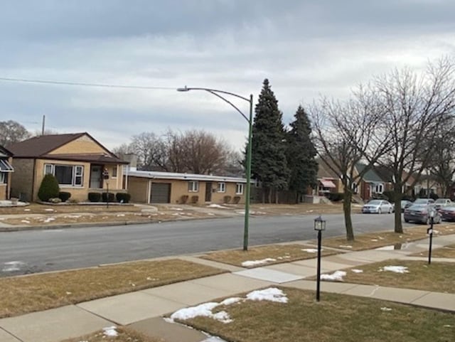 view of road featuring sidewalks, street lighting, and curbs