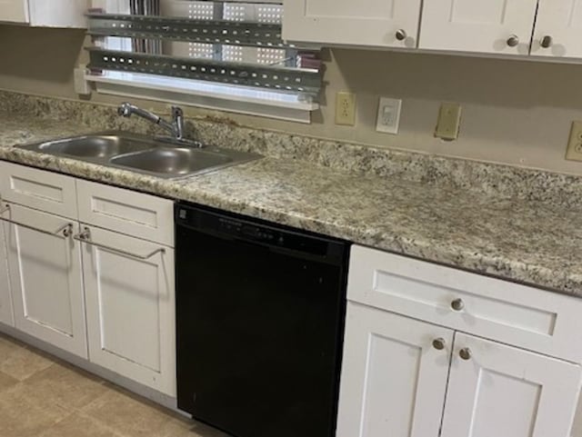 kitchen with dishwasher, light stone counters, a sink, and white cabinetry