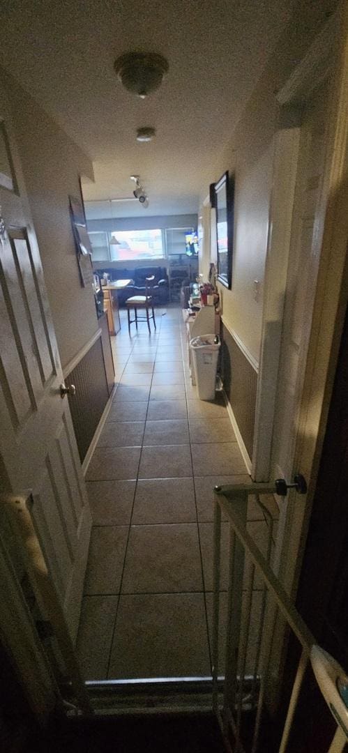 hallway featuring tile patterned flooring