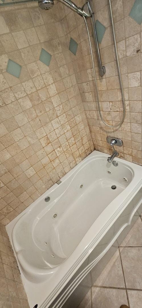 bathroom featuring a combined bath / shower with jetted tub and tile patterned floors