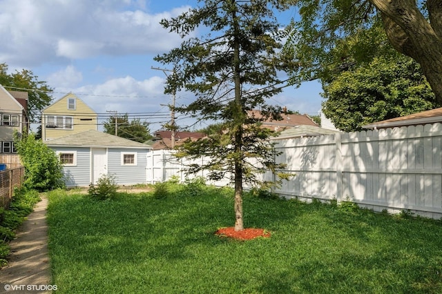 view of yard featuring an outbuilding and a fenced backyard