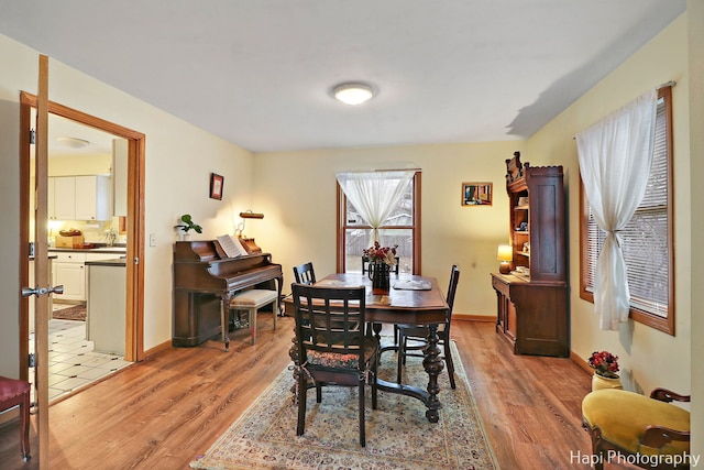 dining room with light wood-style floors and baseboards