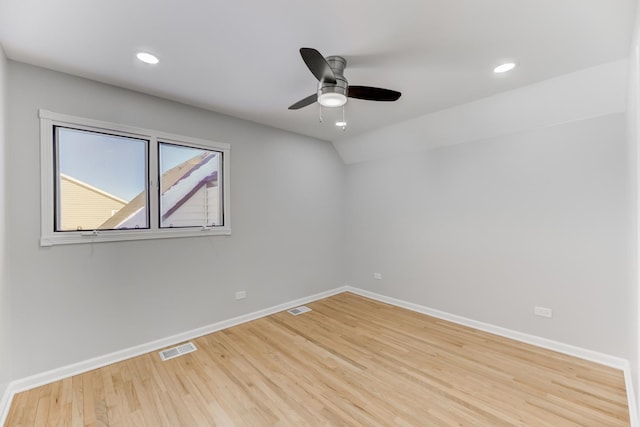 empty room with light wood-style floors, baseboards, and visible vents