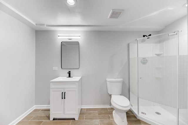 bathroom featuring toilet, a shower stall, visible vents, and vanity