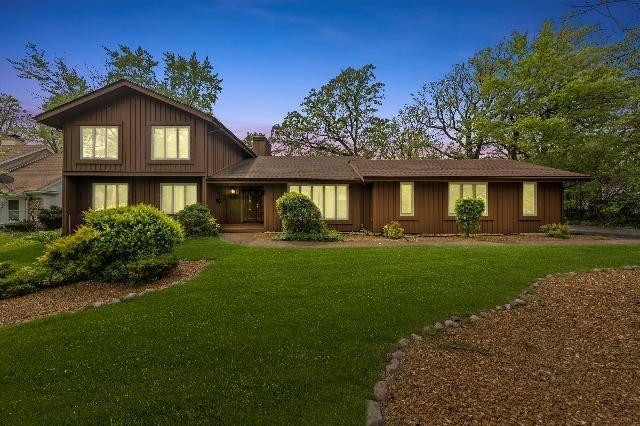 view of front of home with a lawn and a chimney