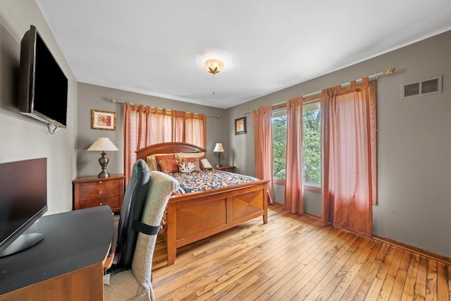 bedroom with light wood-style flooring and visible vents