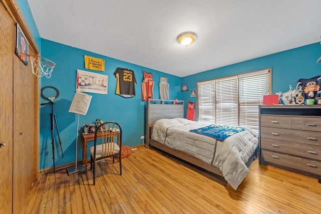 bedroom featuring hardwood / wood-style floors and baseboards