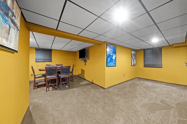 interior space with carpet floors and a drop ceiling