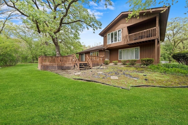 rear view of house featuring a deck and a yard