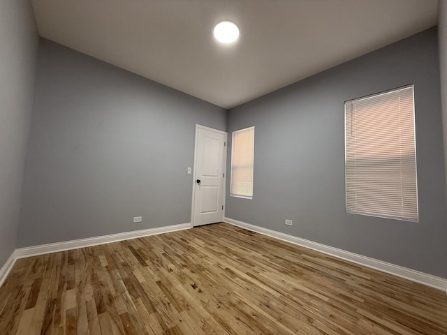 empty room featuring light wood-style floors and baseboards