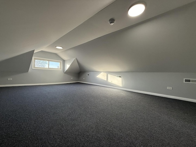 bonus room with lofted ceiling, carpet floors, visible vents, and baseboards