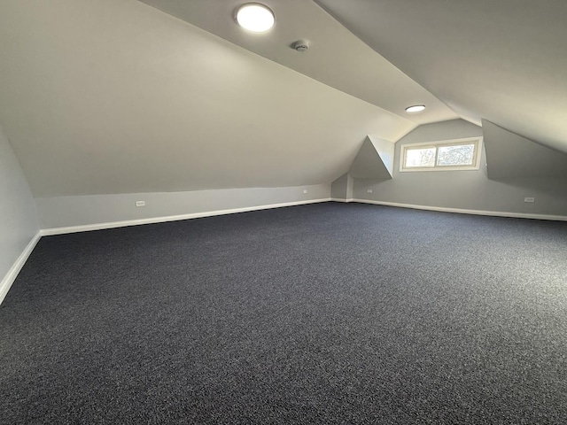 bonus room with lofted ceiling, carpet, and baseboards