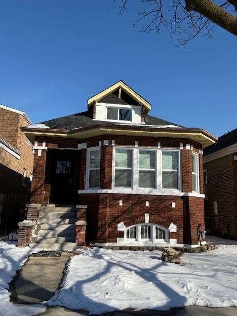 view of front of home featuring brick siding