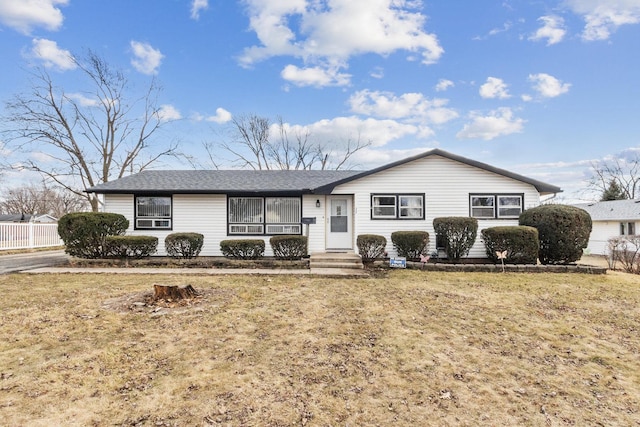 single story home featuring a front lawn and fence