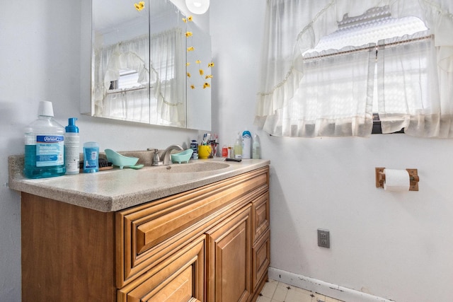 bathroom featuring baseboards and vanity