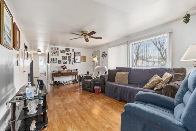 living room with light wood-style flooring and a ceiling fan