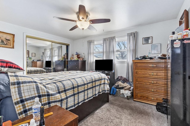 bedroom with carpet floors, a ceiling fan, and a closet