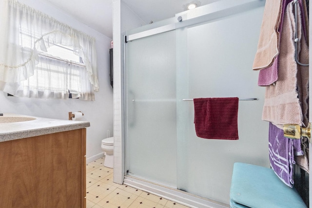 full bathroom with vanity, a shower stall, toilet, and tile patterned floors