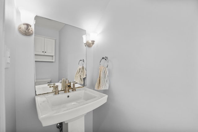 half bathroom with a sink and toilet