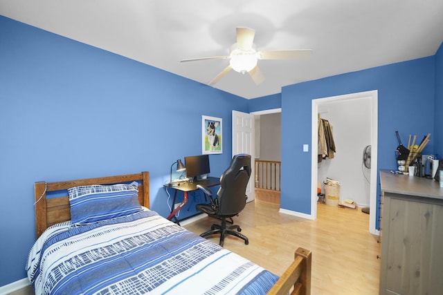 bedroom featuring ceiling fan, baseboards, and wood finished floors