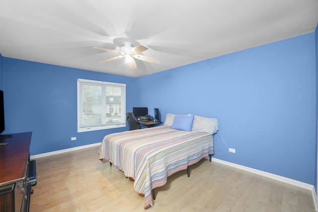 bedroom featuring light wood-type flooring, baseboards, and a ceiling fan