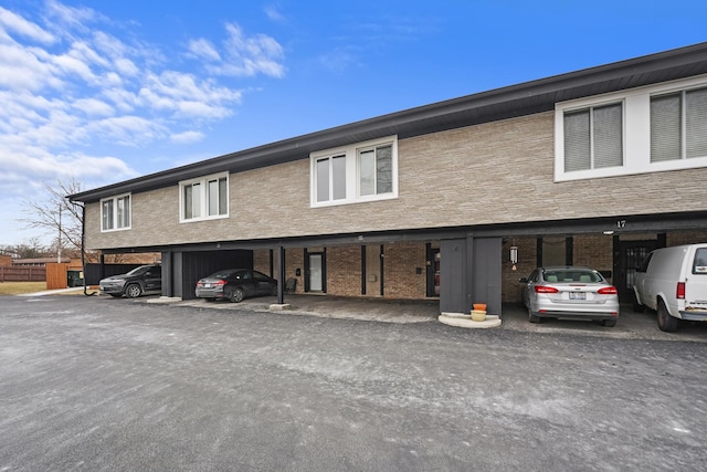 view of front of home with brick siding and covered parking