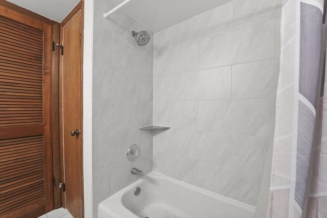 bathroom featuring a closet and shower / tub combo with curtain