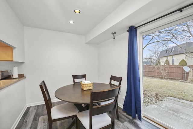 dining room featuring dark wood-type flooring, recessed lighting, and baseboards