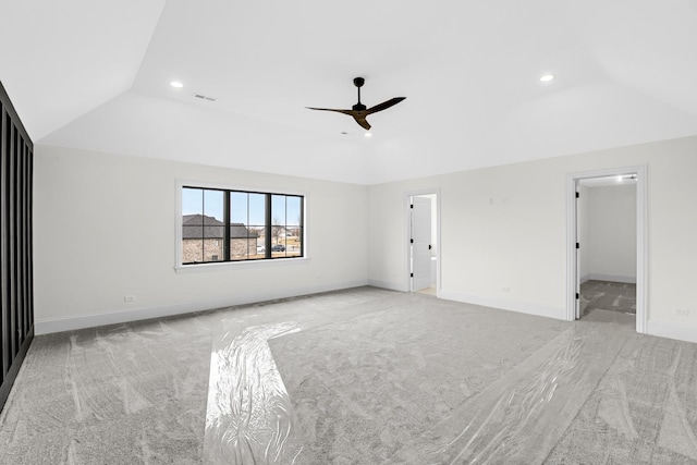 interior space featuring vaulted ceiling, baseboards, and light colored carpet