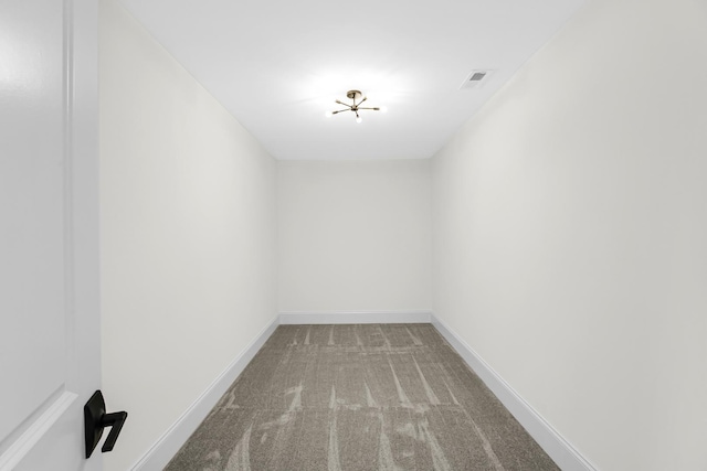 unfurnished room featuring carpet flooring, visible vents, and baseboards