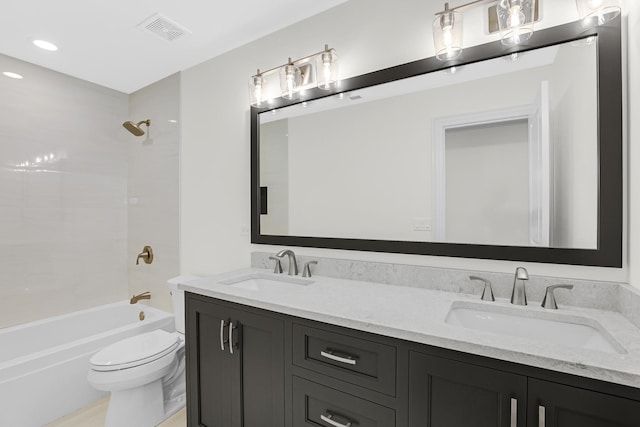 full bathroom featuring toilet, bathing tub / shower combination, a sink, and visible vents