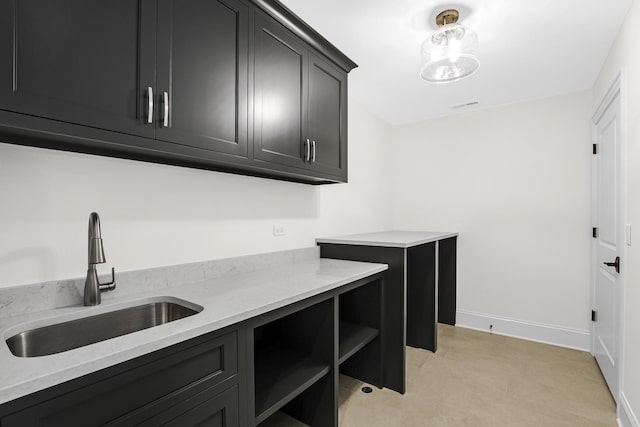 interior space featuring visible vents, a sink, and baseboards