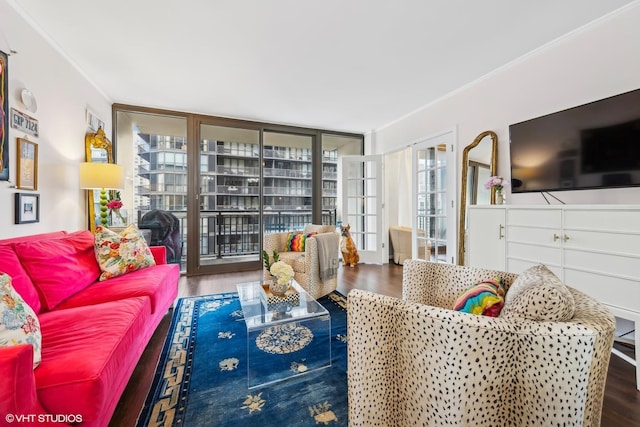 living area featuring ornamental molding, a wall of windows, and wood finished floors