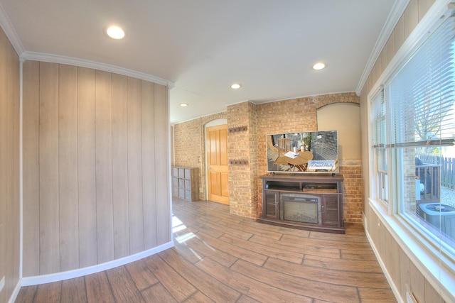 interior space featuring baseboards, recessed lighting, wood finished floors, and crown molding