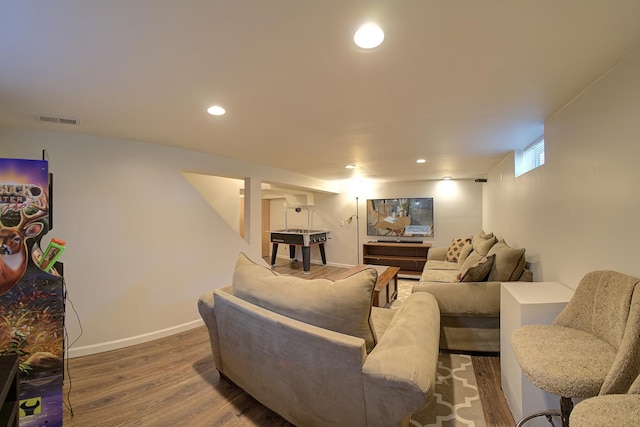 living area with baseboards, wood finished floors, visible vents, and recessed lighting